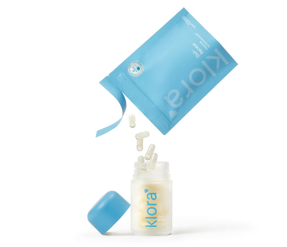 Klora Gut-Renew prebiotic and postbiotic pills pouring into klora refillable glass jar
